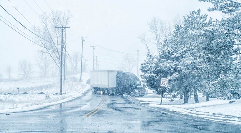 A truck driving on a road in the snow

AI-generated content may be incorrect.